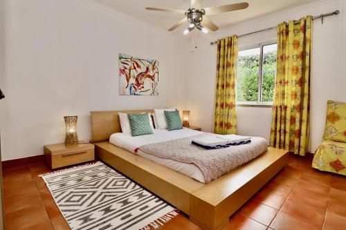 a bedroom with a bed and a window at Casa das Ondas by AnaLodges in Porto Santo