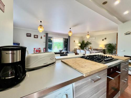 a kitchen with a counter top with a coffee maker at Casa das Ondas by AnaLodges in Porto Santo