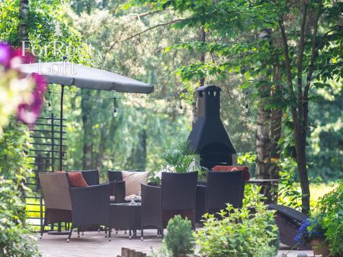 a patio with chairs and a large bottle of wine at ForRest Loft in Poręby Kupieńskie