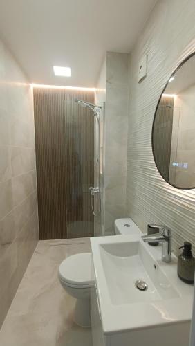 a bathroom with a toilet and a sink and a mirror at VeRa Suite 2 in Silistra