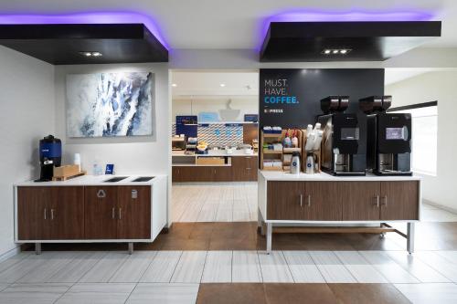 a coffee shop with a counter with a coffee maker at Holiday Inn Express & Suites Chicago West - St Charles by IHG in Saint Charles
