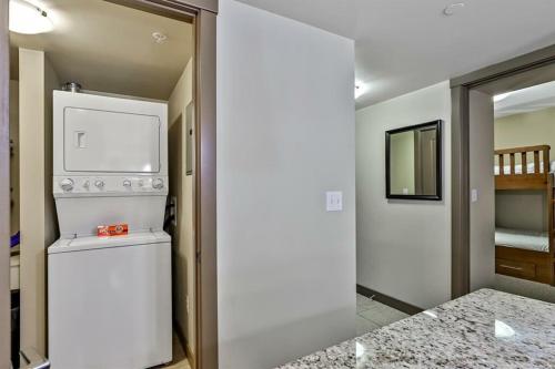 a kitchen with a washer and dryer in a room at Luxury Two Bedroom Condo near Canmore Banff in Dead Man's Flats
