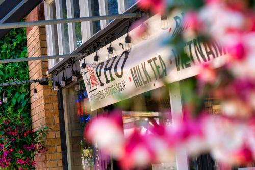 a sign for a store with flowers in front of it at Stay Portland - Moab Vibes in PDX- Walk to Local Coffee & Food in Portland