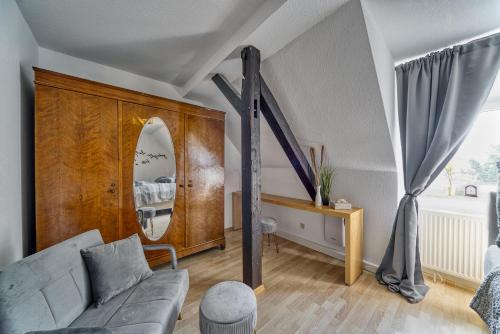 a living room with a couch and a mirror at GreenDesign in Schkopau