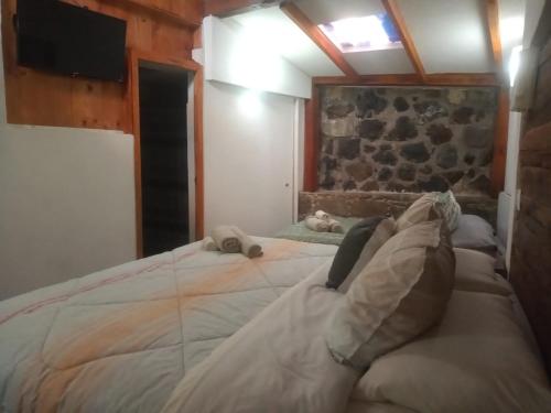 a person laying on a large bed in a room at Posada Las vigas in Zacatlán