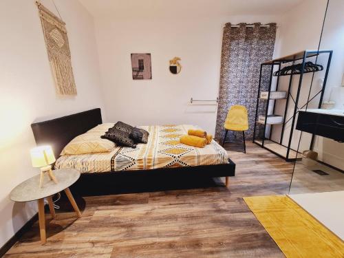 a bedroom with a bed in a room with a piano at Rep - 3B in Millau