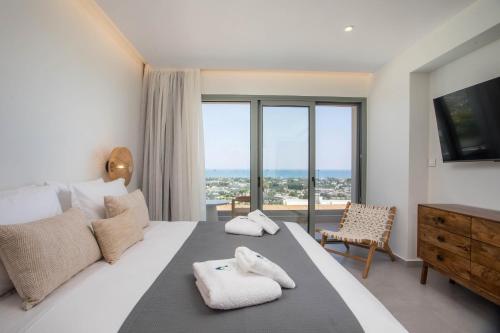 Ένα ή περισσότερα κρεβάτια σε δωμάτιο στο Athoros Luxury Villas