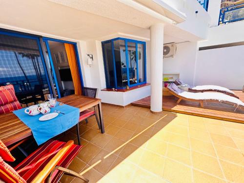 a living room with a table and chairs at Private apartment with stunning ocean views and sunset. in Taurito