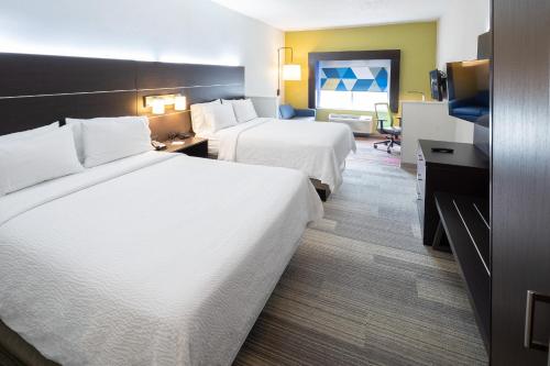 a hotel room with two beds and a television at Holiday Inn Express & Suites Chicago West - St Charles by IHG in Saint Charles