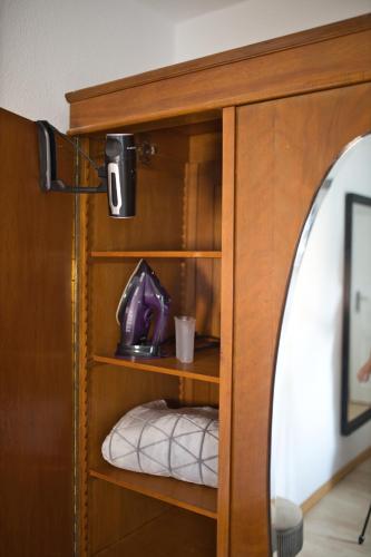 a wooden shelf with a cup in a room at GreenDesign in Schkopau