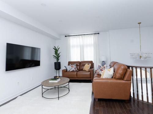 a living room with two couches and a tv at Vacation Home in Vaughan in Vaughan