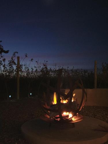 a fire pit in a yard at night at Entrevid suite & spa in Ciudad Lujan de Cuyo