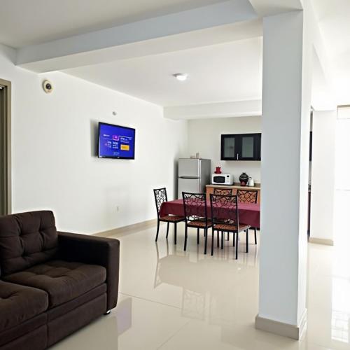 a living room with a couch and a table at Pranaya Haven in Puttalam
