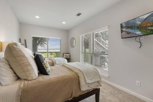 a bedroom with a bed and a large window at La Costa Drive in Montgomery