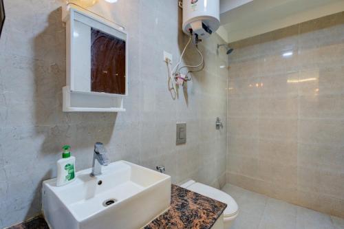 a bathroom with a sink and a toilet at City view stay by Royal Rooms in Noida