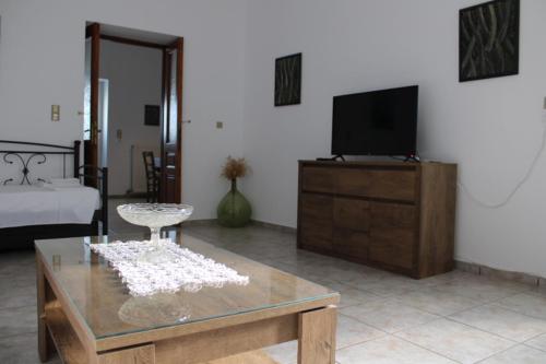 a living room with a tv and a coffee table at Family- House in Chora, kythnos in Kithnos