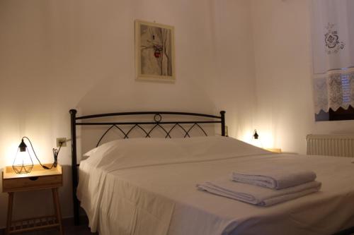 a bedroom with a bed with two towels on it at Family- House in Chora, kythnos in Kithnos