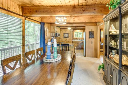 a dining room with a wooden table in a house at Canal Across Street Family Cabin in Breezy Point! in Pequot Lakes