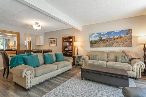 a living room with two couches and a kitchen at On Gore Creek, Pet Friendly, Steps from Free Bus Stop & Great Value in Vail