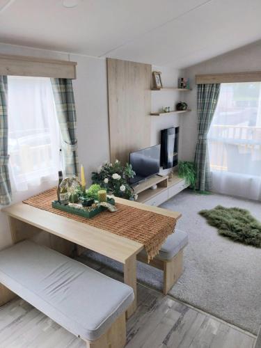 a living room with a table and a couch at Luxury 6 berth Caravan Lytham in Preston