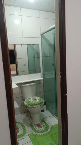 a bathroom with a toilet and a glass shower at Apartamento condominiofechado in Ananindeua