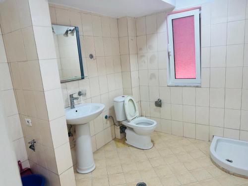 a bathroom with a toilet and a sink at RIA apartment in Himare