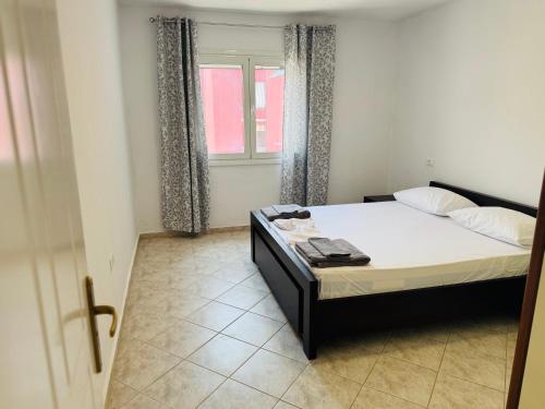 a bedroom with a bed and a window at RIA apartment in Himare