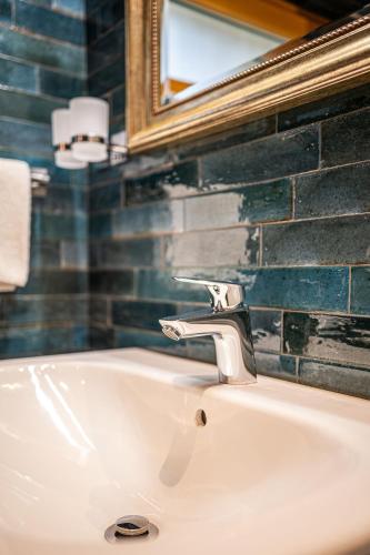 a bathroom sink with a mirror and aaucet at Stodola 63 in Pacov