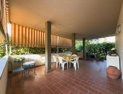 a patio with a table and chairs on it at La Terrazza al Forte in Forte dei Marmi