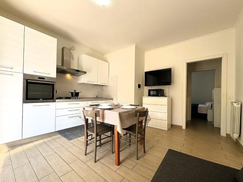 a kitchen with a table and chairs in a room at Nadia House - a stone's throw from the sea! in Fano