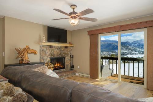 a living room with a couch and a fireplace at Lula in Grand Lake
