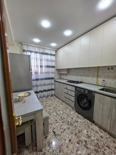 a kitchen with a washer and dryer in it at Royal Apartment #4 in Yerevan