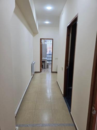 an empty hallway with a door and a tile floor at Royal Apartment #4 in Yerevan