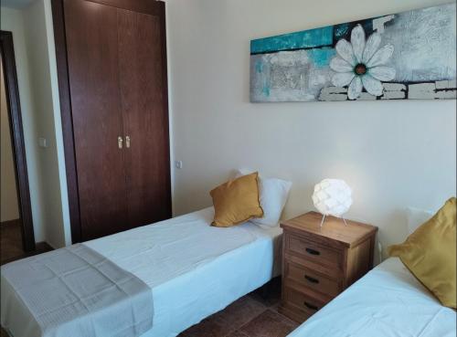 ein Schlafzimmer mit zwei Betten und einem Holzschrank in der Unterkunft Colina Vacacions in Santa Clara