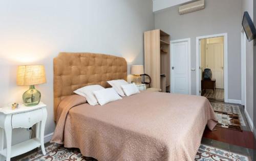 a bedroom with a large bed with a large headboard at Palacio Miraflores in Santa Cruz de Tenerife