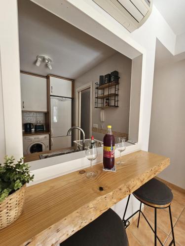 a kitchen with a wooden table with wine glasses on it at 1 Duplex Las Terrazas Cubes in Vélez de Benaudalla