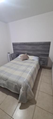 a bedroom with a large bed with a headboard at Casa Jardines del Mirador in San Juan del Río