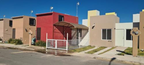 a small red building with a gazebo on a street at Casa Jardines del Mirador in San Juan del Río
