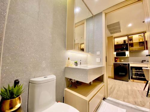 a bathroom with a white toilet and a sink at arom wongamat in Pattaya North