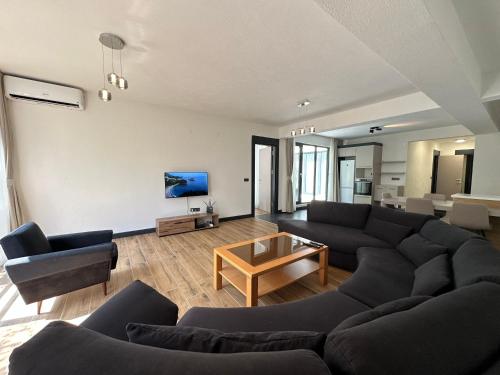 a living room with a couch and a table at Adriatic Masterpiece Residence in Sveti Stefan