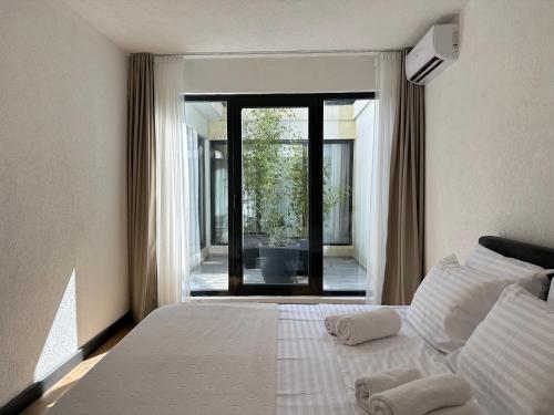 a bedroom with a bed and a large window at Adriatic Masterpiece Residence in Sveti Stefan