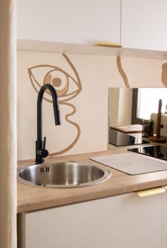 a kitchen counter with a sink in a kitchen at CASA ANANTA Appartements bien-être aux portes du Verdon Refuge slow Life et sensoriel jusqu à 12 pers in La Garde