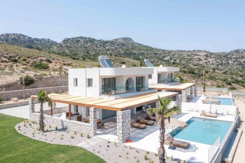 an aerial view of a house with a swimming pool at Athoros Luxury Villas in Afantou