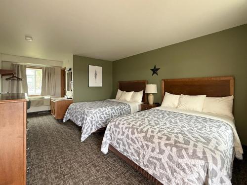 a hotel room with two beds and a kitchen at The Trail Inn & RV Sites - Selby, SD - HWY 12, HWY 83 in Selby