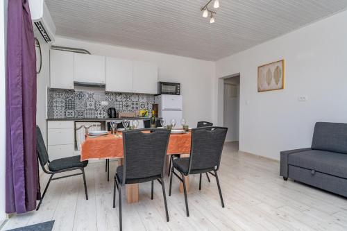a kitchen and dining room with a table and chairs at Sea view apartment Dominique in Cavtat