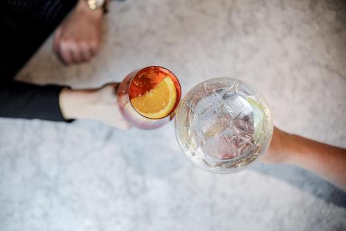 a person holding a drink with an orange slice at Residence Inn by Marriott Ghent in Ghent