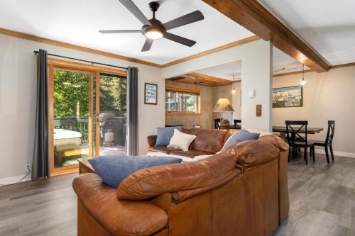 a living room with a couch and a ceiling fan at Private Hot Tub Overlooking Gore Creek, Parking for 4, Updated Townhome in Vail