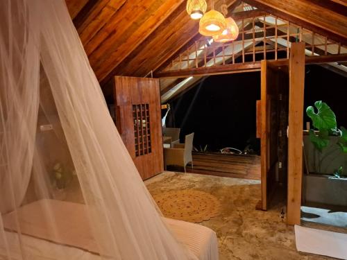 a room with a bed with a veil at Mangle House Cabañas Ladrilleros in Buenaventura