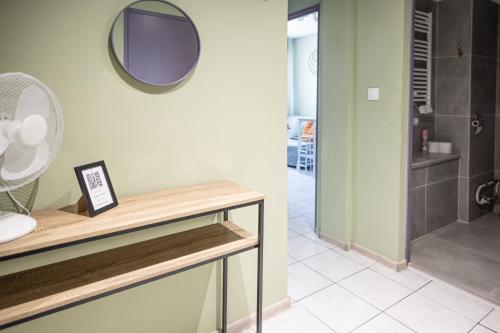 a bathroom with a mirror on the wall and a shower at Fanta flat France Suisse in Saint-Louis