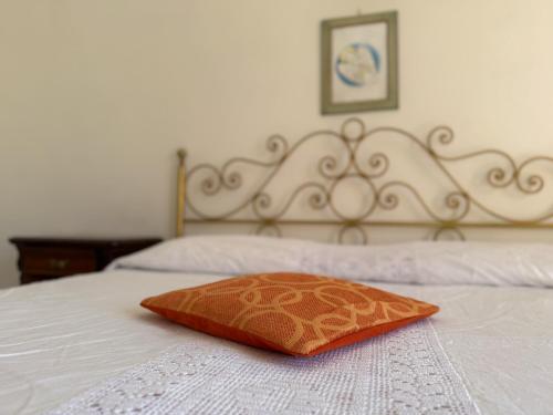 a pillow on a bed with a white blanket at La Terrazza al Forte in Forte dei Marmi